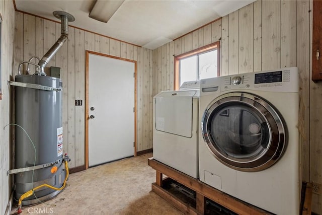 laundry area featuring independent washer and dryer, strapped water heater, and laundry area