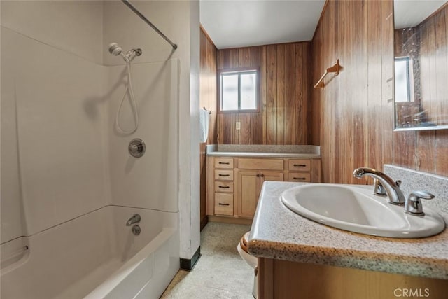 full bathroom featuring shower / bath combination, wooden walls, and vanity