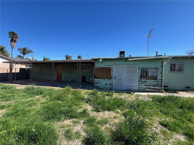 rear view of property with crawl space