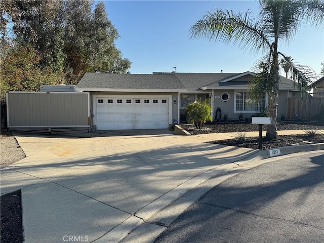 single story home with a garage, fence, concrete driveway, and stucco siding