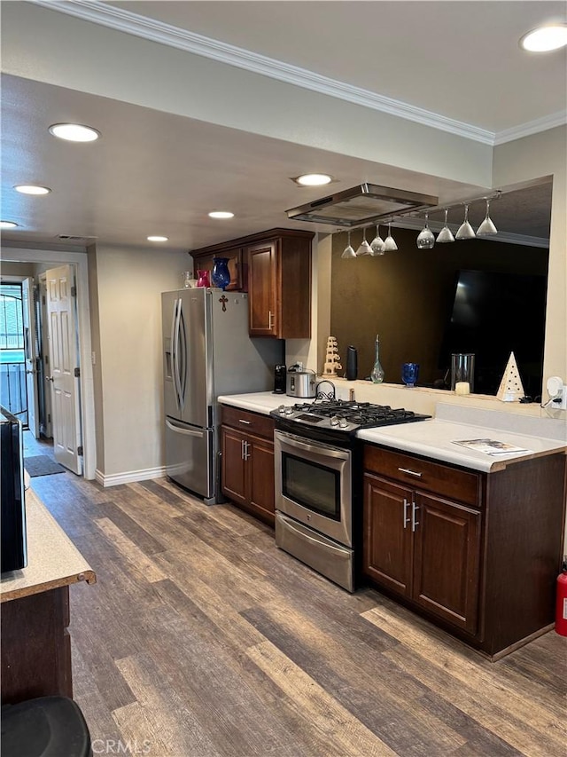 kitchen with dark wood-type flooring, stainless steel appliances, crown molding, and light countertops