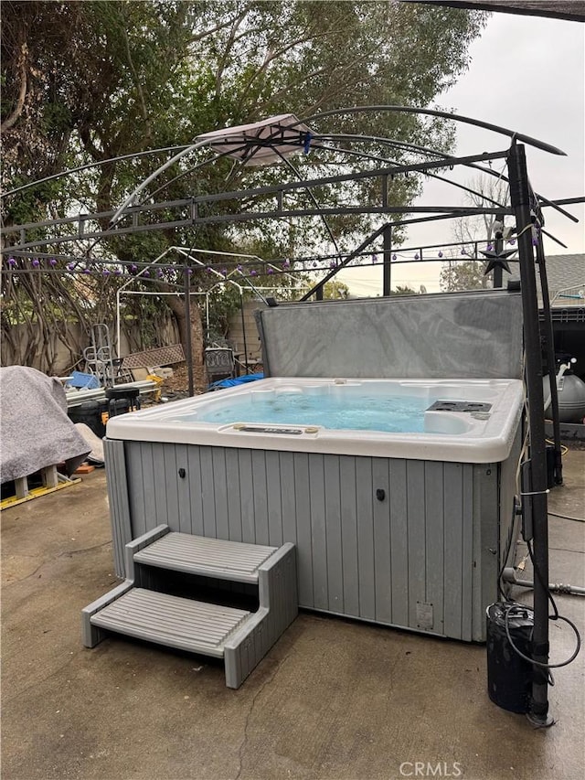 view of pool with a hot tub