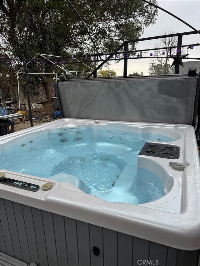 view of swimming pool featuring a hot tub