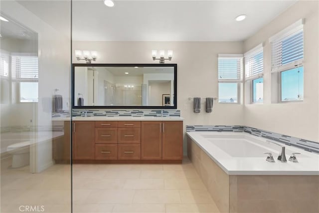 full bath featuring plenty of natural light, vanity, toilet, and a bath