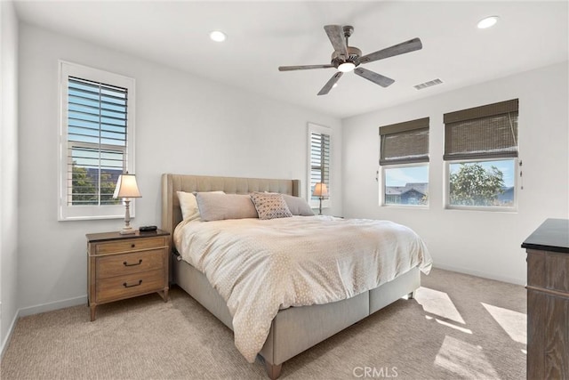 bedroom with light carpet, recessed lighting, visible vents, and baseboards