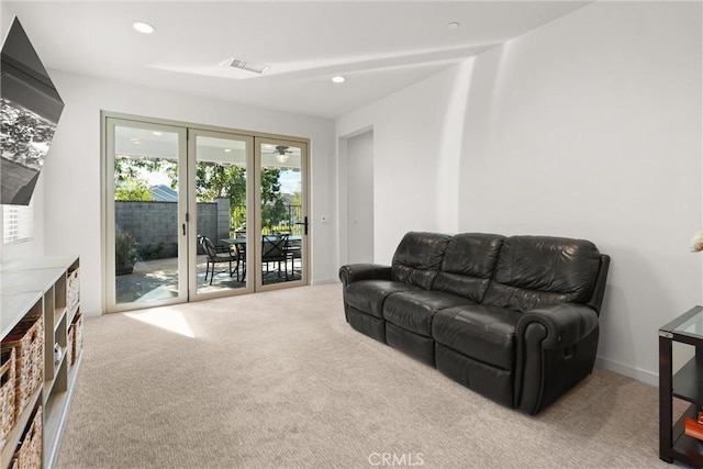 living area featuring recessed lighting, visible vents, baseboards, and light colored carpet