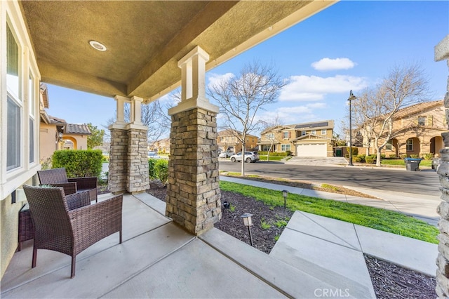 view of patio / terrace with a porch and a residential view