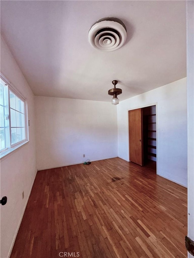 empty room featuring wood-type flooring