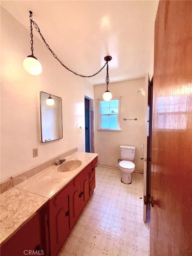 bathroom featuring vanity, toilet, and tile patterned floors