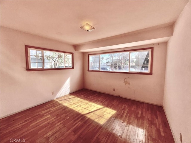 unfurnished room featuring hardwood / wood-style flooring