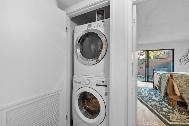 clothes washing area featuring laundry area and stacked washer / drying machine