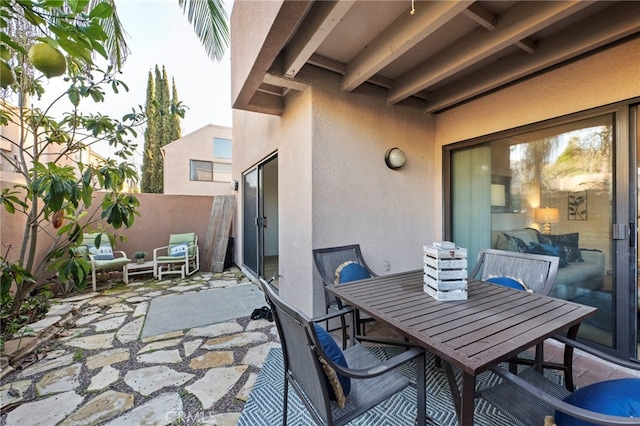 view of patio featuring fence and outdoor dining space