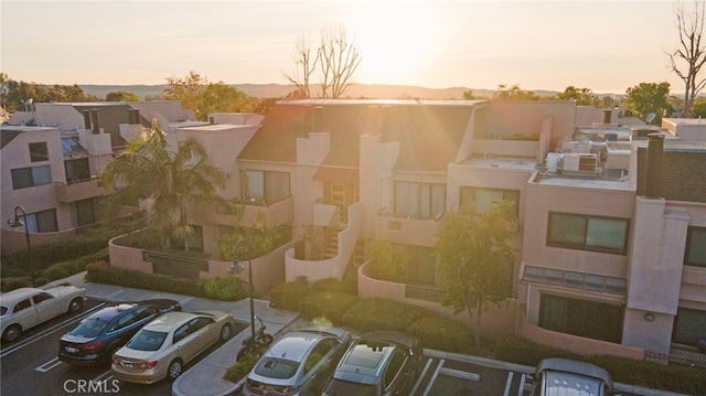 property at dusk featuring uncovered parking and a residential view