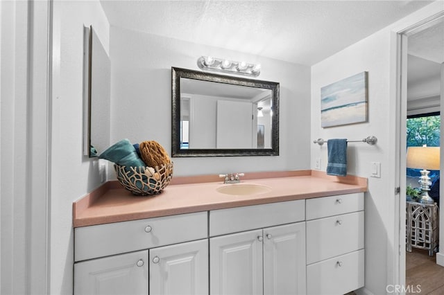 bathroom with a textured ceiling and vanity