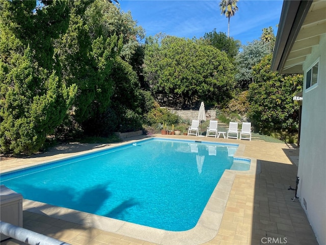 outdoor pool featuring a patio