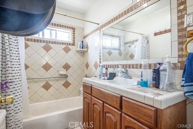 bathroom featuring shower / tub combo and vanity