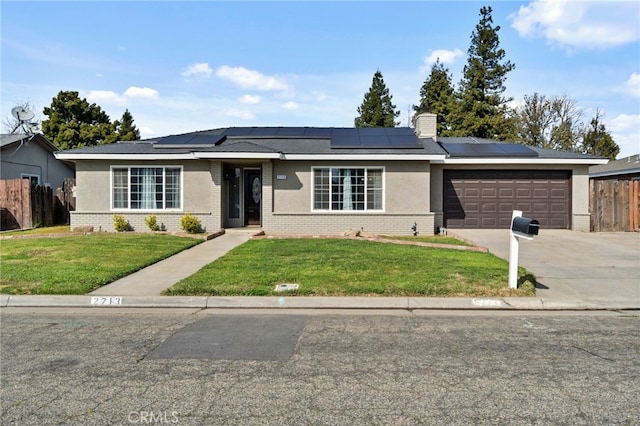 ranch-style house featuring an attached garage, fence, concrete driveway, roof mounted solar panels, and a front lawn