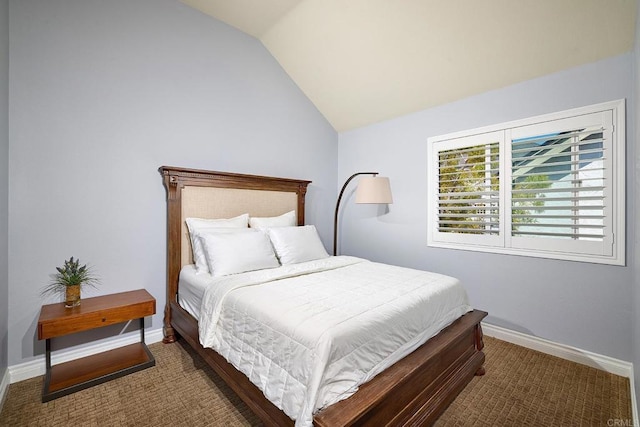 carpeted bedroom featuring vaulted ceiling and baseboards