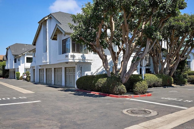 view of building exterior with uncovered parking