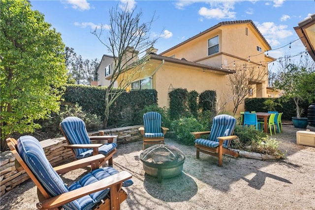 view of patio / terrace featuring an outdoor fire pit