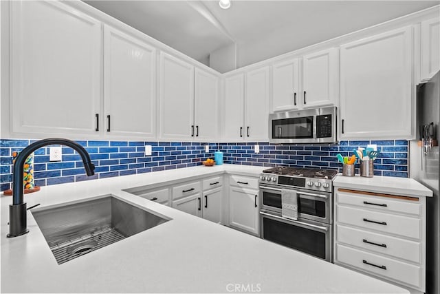 kitchen featuring white cabinetry, appliances with stainless steel finishes, and light countertops