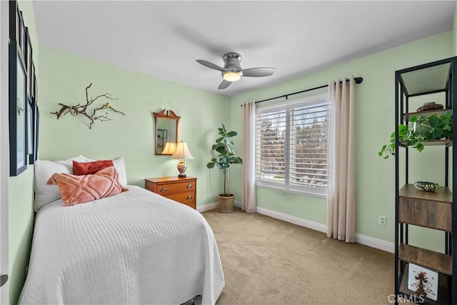 bedroom with baseboards, a ceiling fan, and light colored carpet