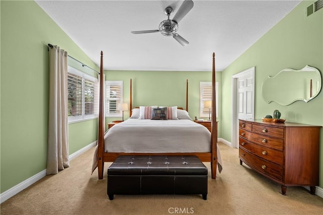 bedroom featuring a ceiling fan, light carpet, visible vents, and baseboards