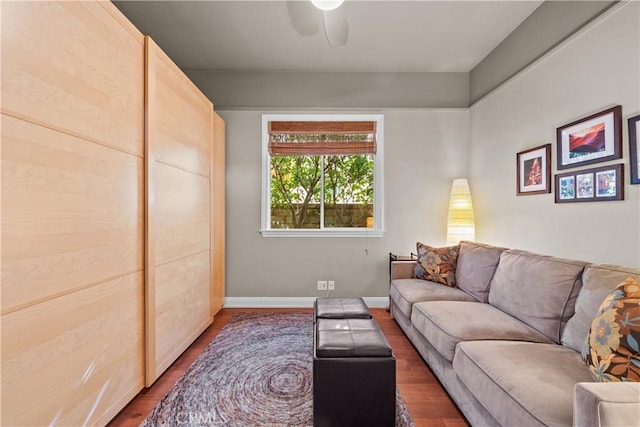 living room featuring ceiling fan, wood finished floors, and baseboards