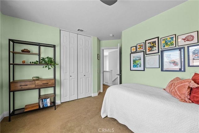 carpeted bedroom with baseboards, visible vents, and a closet