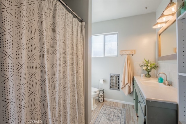 full bathroom featuring decorative backsplash, toilet, a shower with curtain, wood finished floors, and vanity