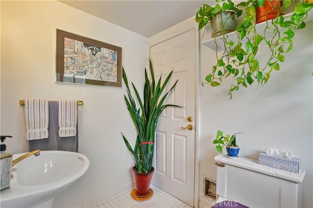 bathroom with tile patterned flooring and a sink