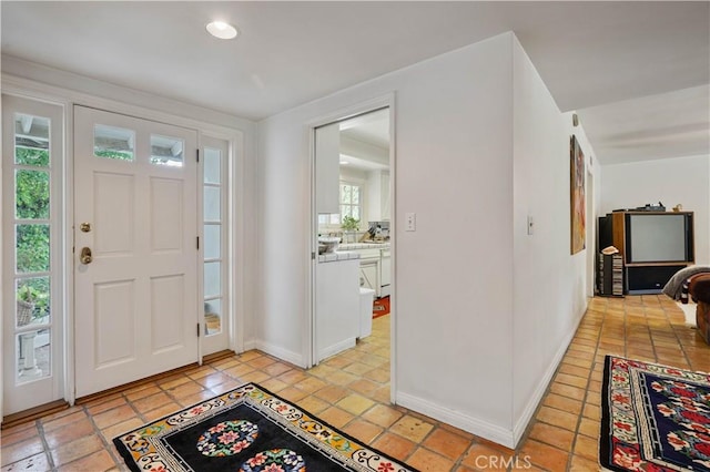 foyer featuring baseboards and recessed lighting