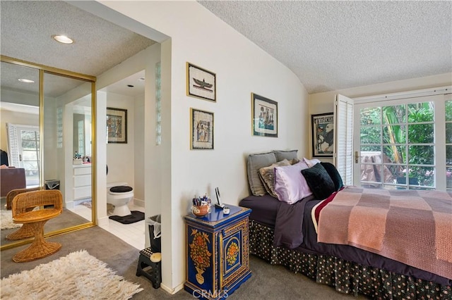 bedroom with carpet, vaulted ceiling, and a textured ceiling