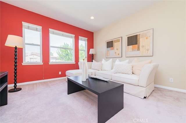 living room featuring recessed lighting, baseboards, and light colored carpet