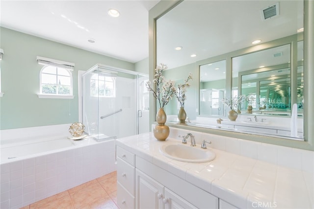 bathroom with visible vents, tile patterned floors, a garden tub, vanity, and recessed lighting