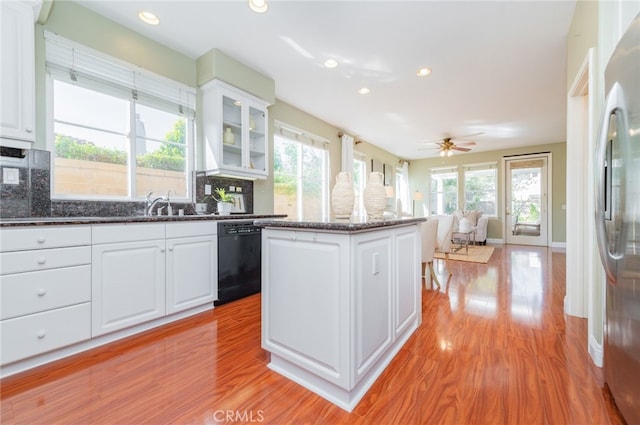 kitchen featuring white cabinetry, stainless steel refrigerator, and dishwasher