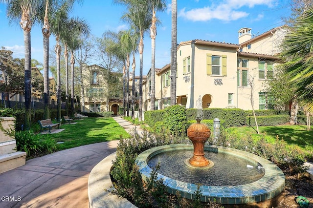 view of property's community featuring a yard