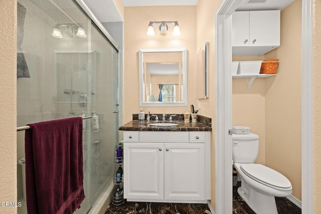 bathroom featuring a stall shower, visible vents, vanity, and toilet