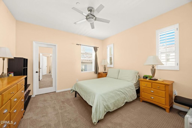 bedroom featuring baseboards, a ceiling fan, and light colored carpet