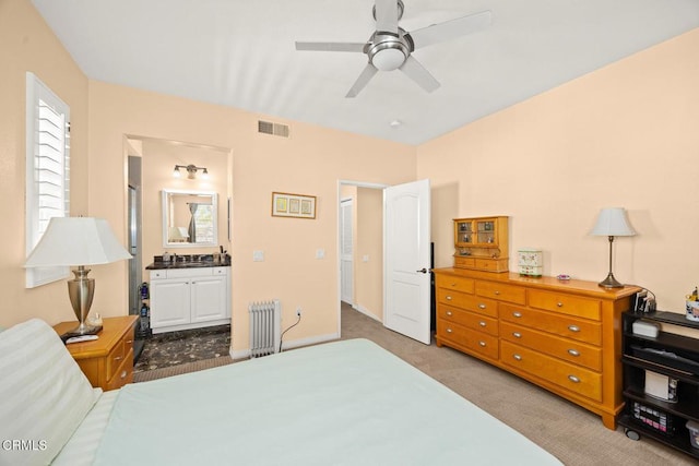 bedroom featuring radiator heating unit, multiple windows, visible vents, and light colored carpet