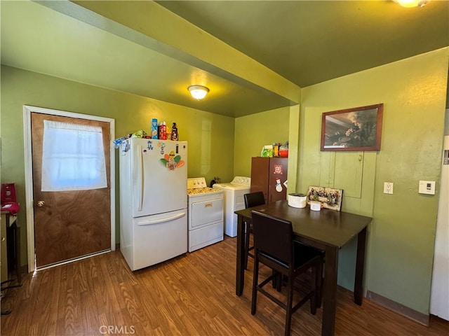 kitchen featuring washer / dryer, freestanding refrigerator, and wood finished floors