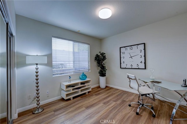 office area with baseboards and wood finished floors