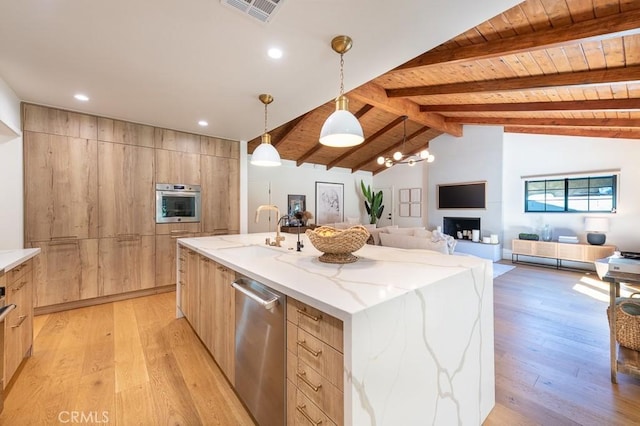 6164 Fenwood Ave, Woodland Hills, CA 91367 - kitchen with light brown cabinetry, modern cabinets, appliances with stainless steel finishes, light wood finished floors, and a sink