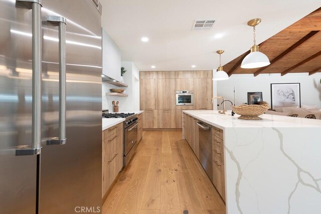 6164 Fenwood Ave, Woodland Hills, CA 91367 - kitchen with premium appliances, modern cabinets, light brown cabinetry, a sink, and beam ceiling