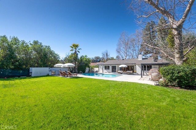 6164 Fenwood Ave, Woodland Hills, CA 91367 - rear view of property featuring a patio area, an outdoor pool, and a chimney