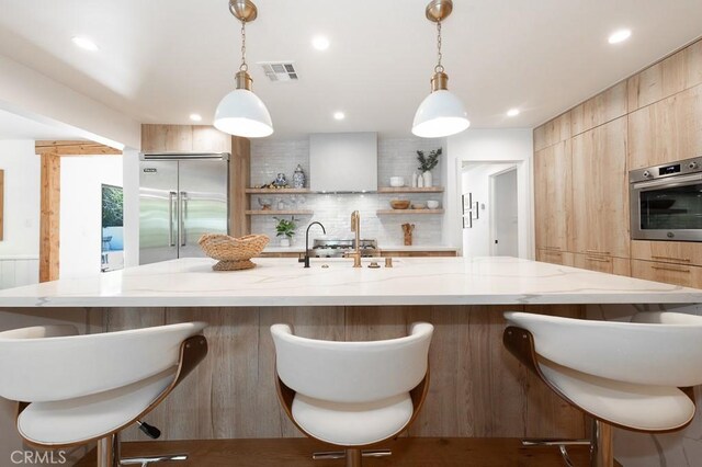 6164 Fenwood Ave, Woodland Hills, CA 91367 - kitchen featuring stainless steel appliances, modern cabinets, open shelves, decorative backsplash, and light stone countertops