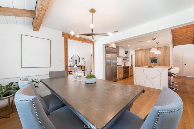 6164 Fenwood Ave, Woodland Hills, CA 91367 - dining room featuring light wood-style flooring and a chandelier