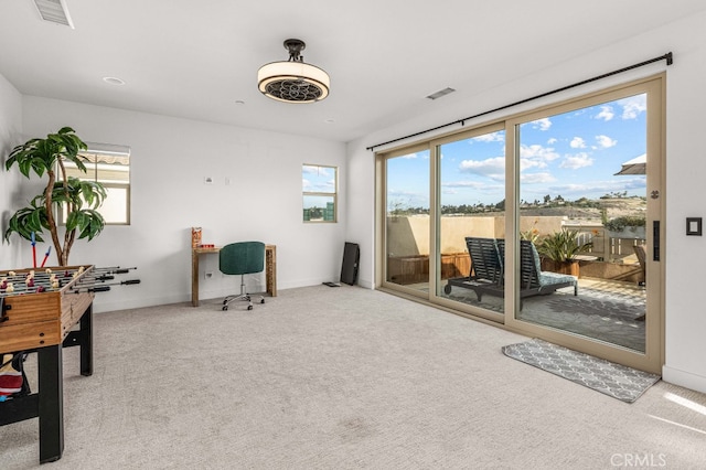 interior space with light carpet, visible vents, and baseboards