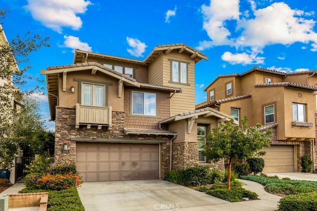 view of front of property with an attached garage, stone siding, driveway, and stucco siding