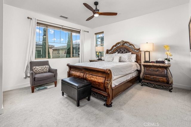 carpeted bedroom with ceiling fan, visible vents, and baseboards